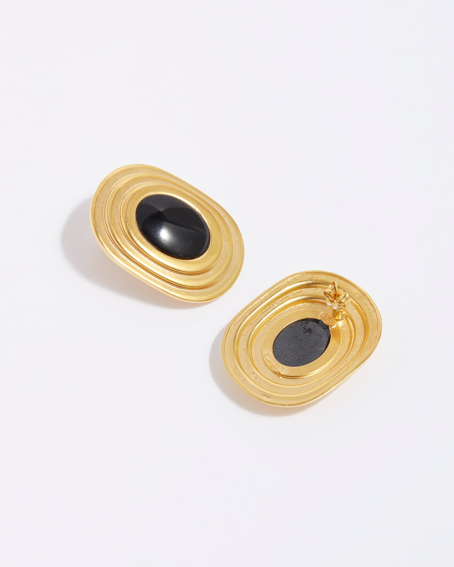 product shot of oversized gold plated silver stud earrings with oval black onyx centre