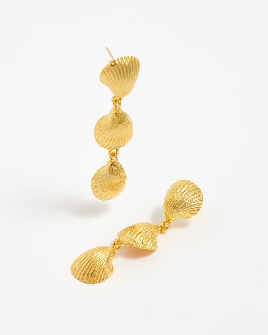 Product shot of 3 gold shell drop earrings on a white background.