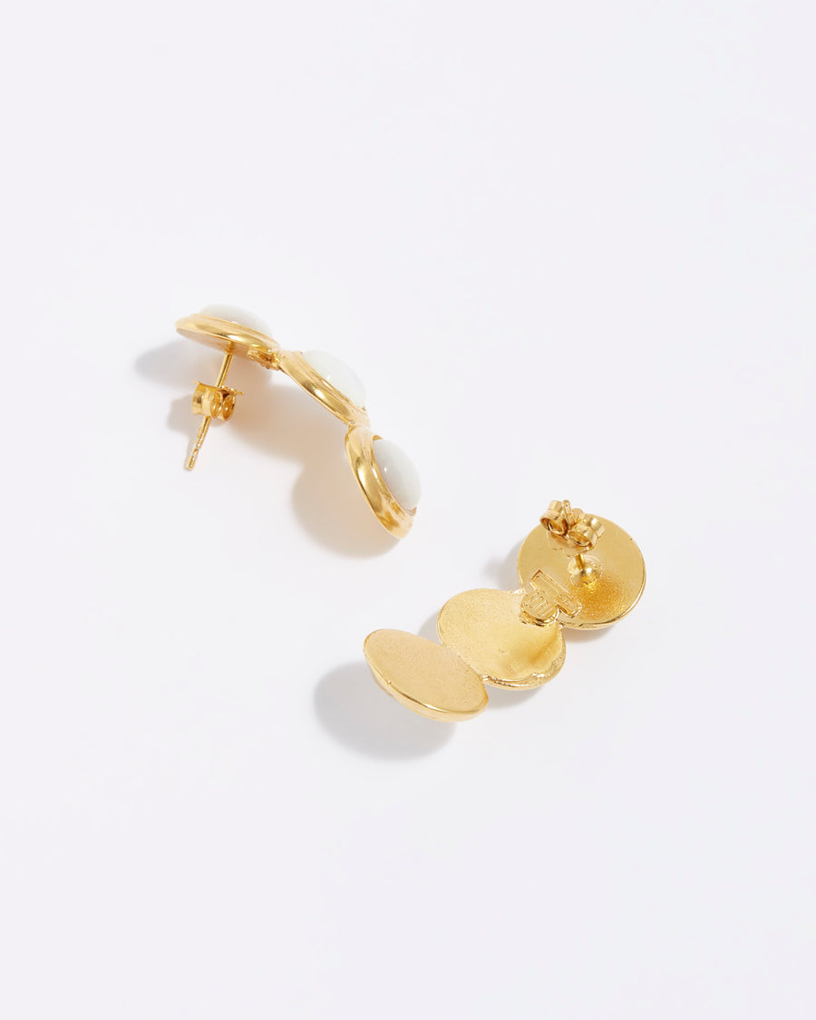 product shot of 3 stone pearl earrings set in yellow gold plated silver in a linear and curved shape