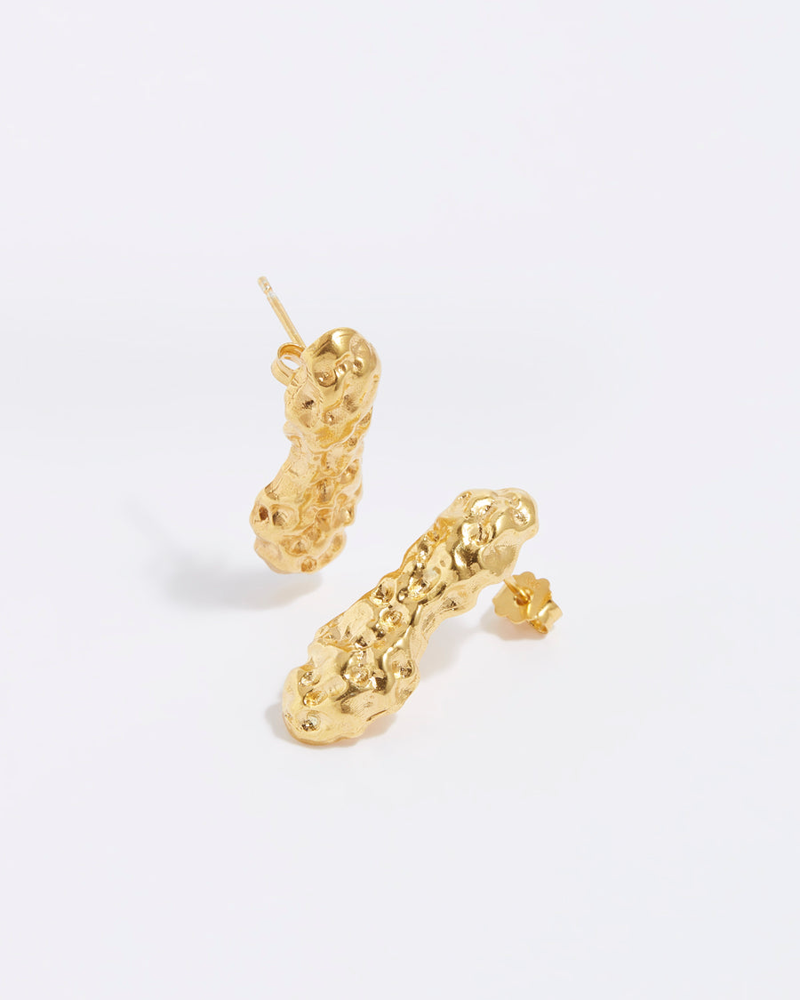 product shot of chunky, gold bar stud earrings with a bumpy, organic finish