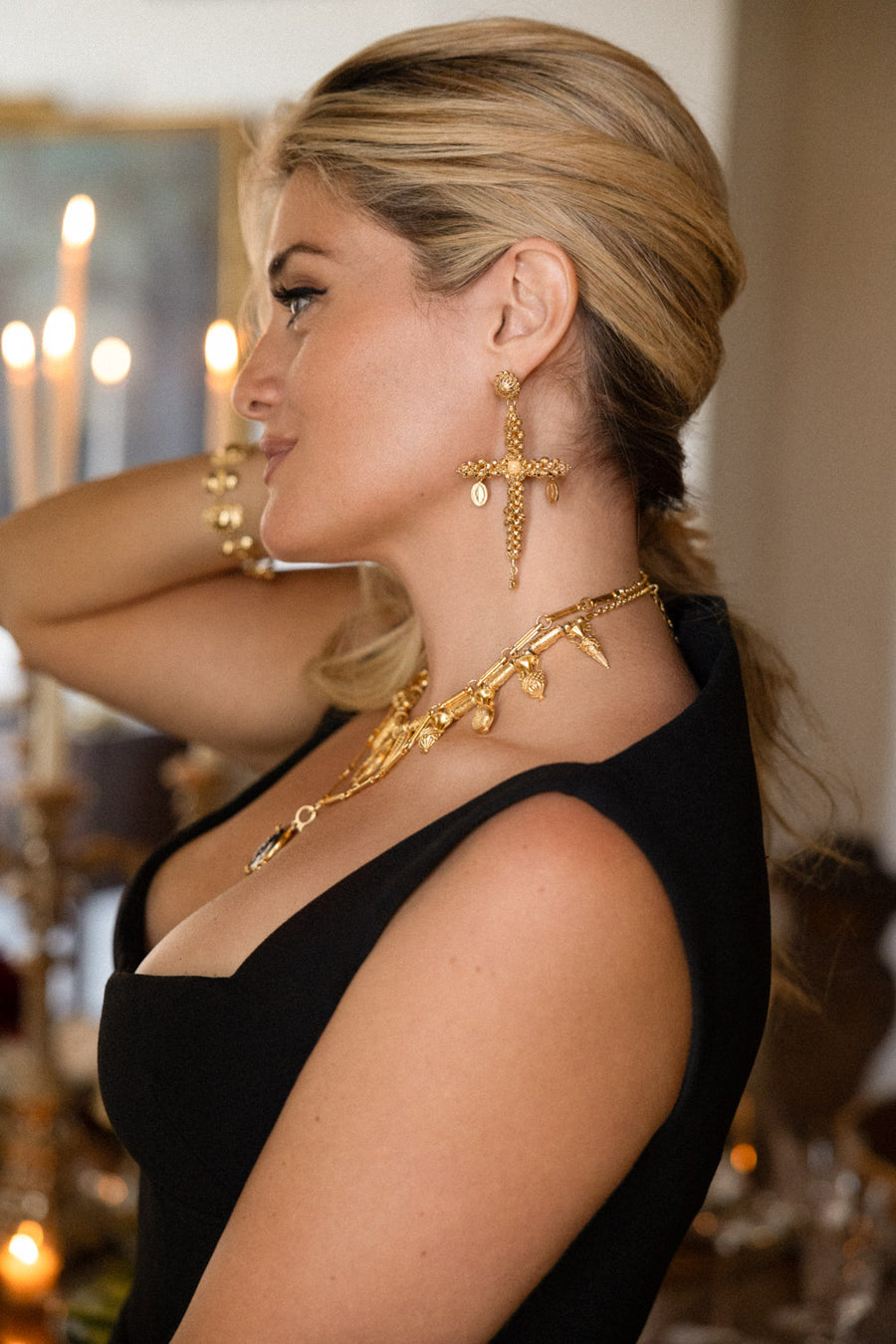 Daphne Oz wearing gold cross earrings shown from the side from her collaboration with soru 