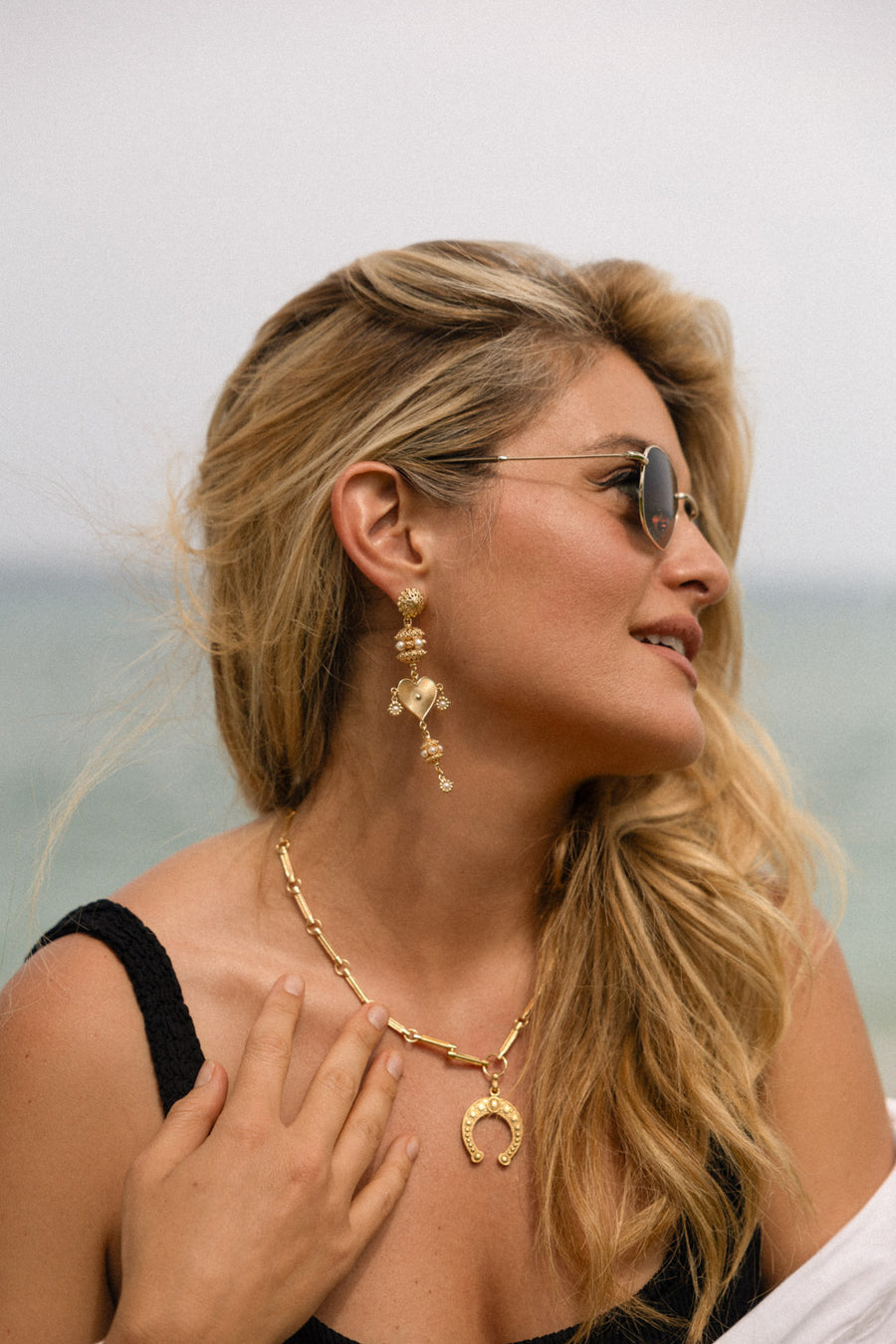 Daphne oz wearing long heart earrings with pearls and filigree detail 