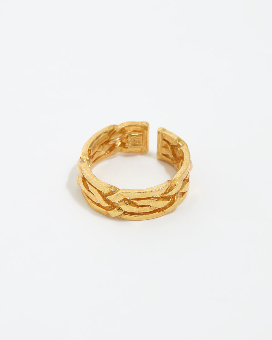 close up image shot of gold braided ring on a white back ground