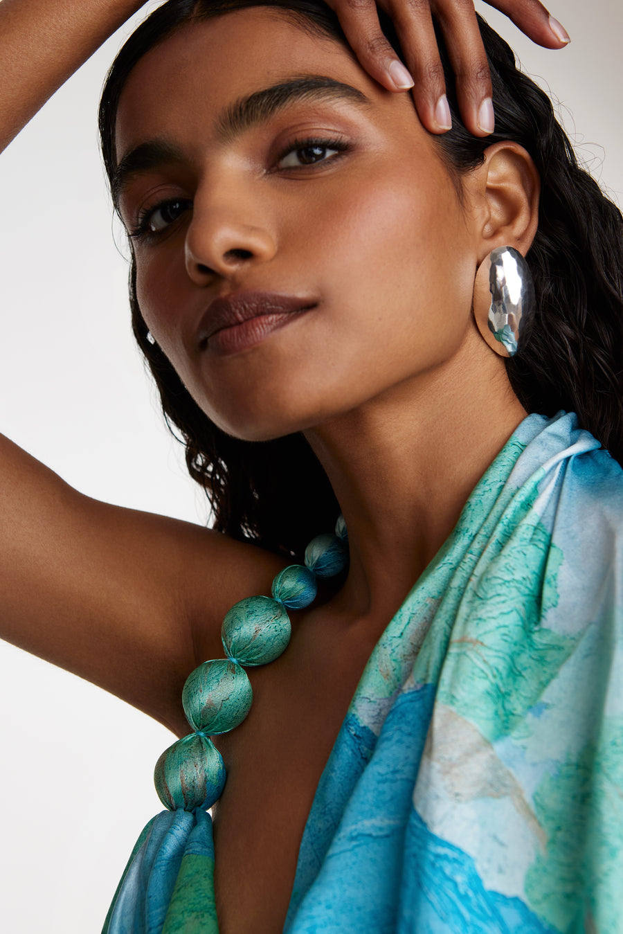 Model shot wearing soru jewellery silver large domed textured earrings