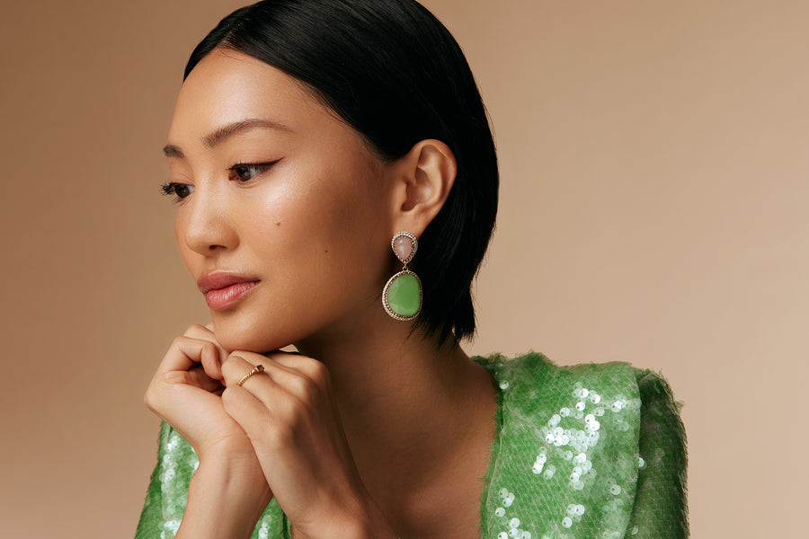 model shot of double drop pink rose quartz and green gemstone earrings surrounded by crystals