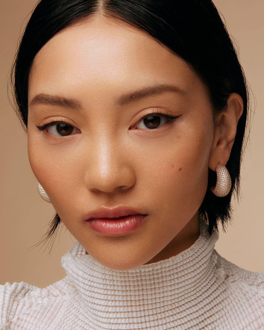 model shot of gold plated earrings with clear crystals hoop earrings