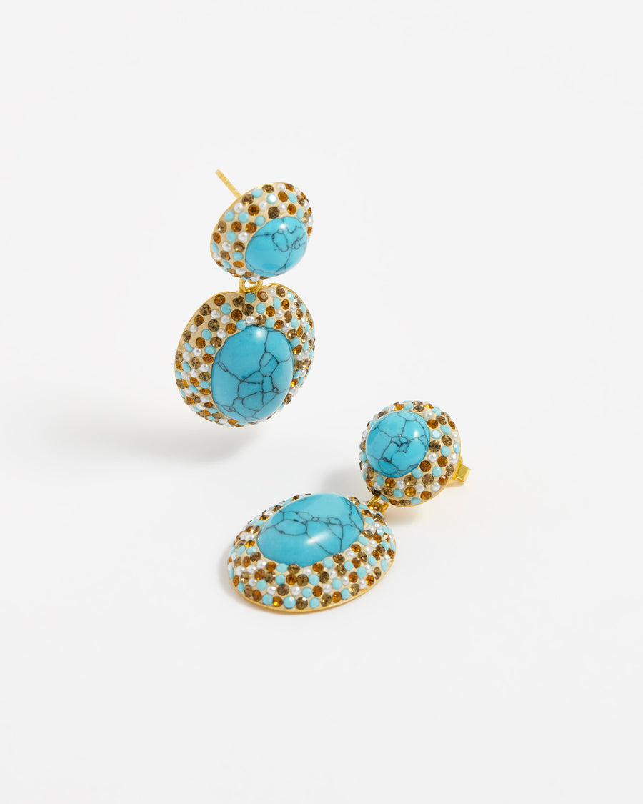 product image on white background of double-drop earrings featuring vibrant turquoise gemstones surrounded by a mix of sparkling orange and turquoise crystals and mini pearls.