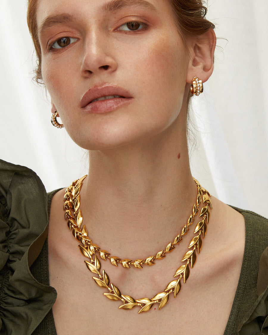 Soru jewellery model shot showing gold hoop earrings with beaded pearl detail